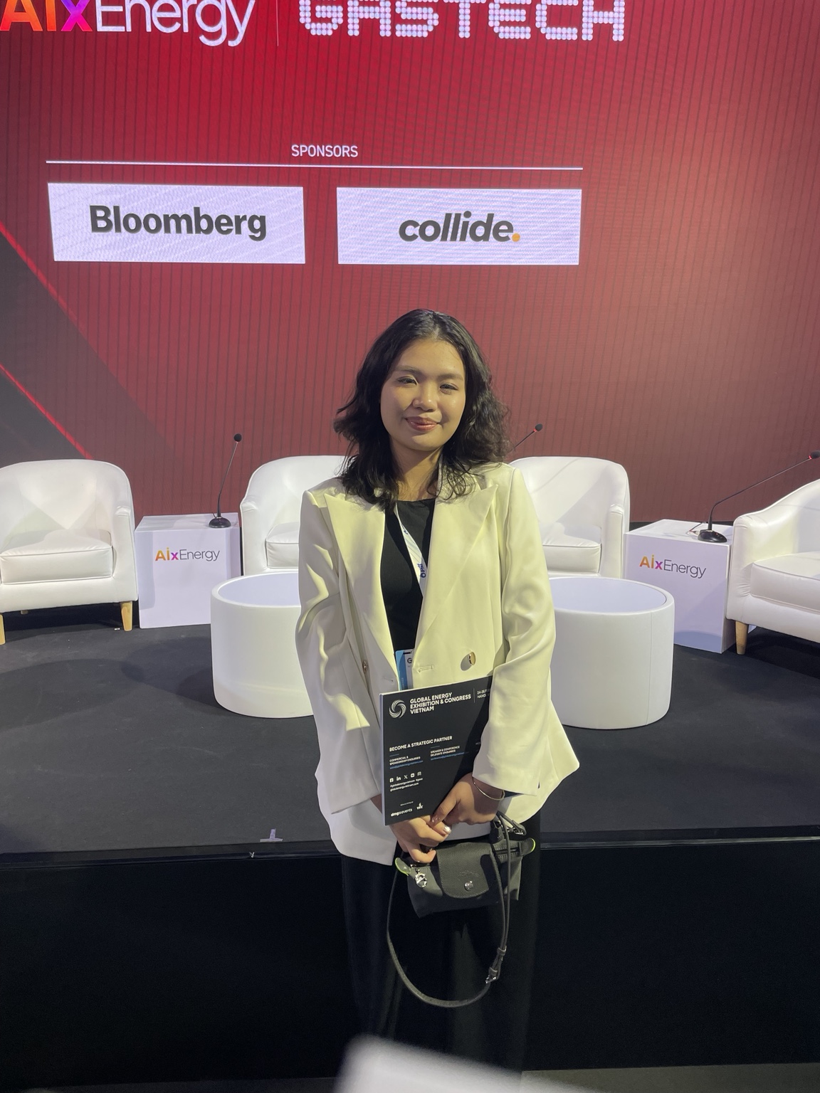 Olivia Nguyen of dmg events with the Global Energy Exhibition and Congress Vietnam brochure at Gastech in Bangkok